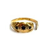 An 18ct gold gypsy ring set with sapphires and diamond chips (af), 1.6g