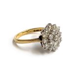An 18ct gold and diamond cluster ring, set with 19 brilliant cut diamonds, the central diamond