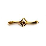 A 9ct gold bar brooch set with a single red paste, 4cm long, approx. 0.9g
