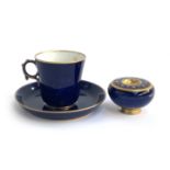 An early 20th century Sevres porcelain teacup and saucer, cobalt blue heightened in gilt, marked to
