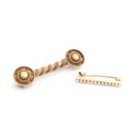 A 14ct gold lace pin set with a row of seed pearls, 2.5cm long, approx. 1.2g; together with a 19th