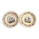 A pair of 19th century hand painted Derby plates, c.1810, painted by Richard Dodson, the central
