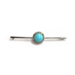 An 18ct white gold bar brooch set with a central turquoise cabochon surrounded by diamonds,