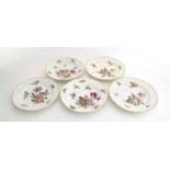 A set of five 20th century Meissen plates, with hand painted floral design, the rim heightened in