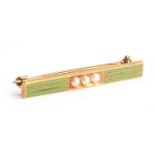 A small 14ct gold brooch with lime green enamel stripe decoration, set with three central seed