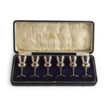 A George V cased set of six silver thistle tots, Robinson & Co. Ltd Singapore Kuala Lumpur,