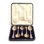 A Victorian cased set of four silver gilt King's pattern and scalloped serving spoons and a tea