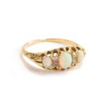 A gold ring set with three opals and diamonds, tests as 22ct, size N 1/2, approx. 2.5g