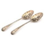 A matched pair of George III silver berry spoons, one by Thomas Streetin, London 1814, the other