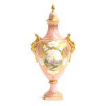 An early 20th century Coalport lidded urn, pink ground heightened in gilt, with a hand painted panel