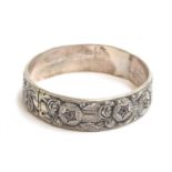 A 19th century French silver bangle, with repousse rose design, bearing boar's head mark, 7cm