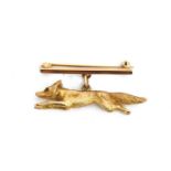 A 9ct gold bar brooch in the form of a running fox, 4.5cm long, approx. 13.5g