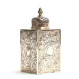 A Victorian silver tea canister of square form with circular lid, each side with repousse scroll