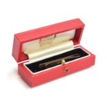 A 9ct gold Cartier tie clip, 5cm long, approx. 5.3g, in a red Cartier velvet lined box