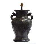 A Chinese bronze vase, decorated with archaic stylised animals, fitted for electricity, 32.5cm