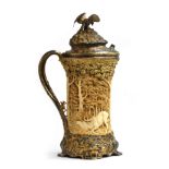 A massive silver gilt and ivory tankard by J Fischer, Budapest, c.1900, the hinged lid surmounted by