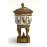A 19th century French hand painted porcelain and ormolu potpourri, decorated with panels of floral