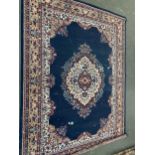 A large blue ground rug, 325x241cm