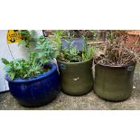 A pair of green glazed planters 30cmH; together with a blue glazed planter, 39cmD