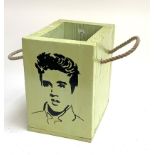 A wooden box stencilled with an image of Elvis