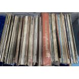 A large blue crate of various vinyl LPs