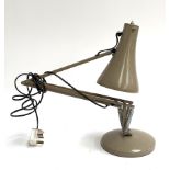 An anglepoise lamp, in mushroom