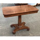A Regency rosewood centre table, with two end drawers, on gun barrel column and quatrefoil base,