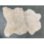 A sheepskin rug, approx. 100cmL