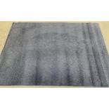 A blue shag pile rug, 240x170cm