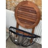 A powder coated window basket; together with a teak circular garden table