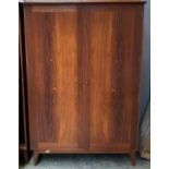 A mid century rosewood veneer hanging wardrobe, by A Younger Ltd, with single hanging rail,
