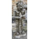 A large composite stone figure of a totemic figure grasping a large rod, 105cmH