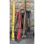 A quantity of long handled tools to include forks, sledge hammers, pickaxe etc