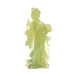 A Chinese carved jade figure of Guanyin, the Bodhisattva of compassion, 19cm high