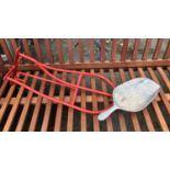 A red saddle and bridle rack, together with a feed trowel