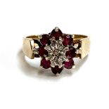 A 9ct gold floral cluster ring set with rubies and an illusion set diamond, size N 1/2, approx. 3.9g
