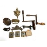 A mixed lot to include table winders, brass door knockers; lock and key fittings etc