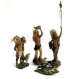 A set of four resin figures of Native Americans and wolves, the largest 77cmH to top of spear