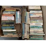 Two boxes of paperback books to include John Le Carre, Desmond Bagley, Agatha Christie etc