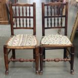 A pair of ash spindle back chairs, with rush seats