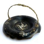 A Victorian black lacquered papier mache swing handled table basket with mother of pearl floral