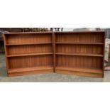 A pair of mid century teak bookshelves, each with two adjustable shelves, bearing label for Gordon