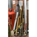 A quantity of garden tools to include sledgehammer, spades, rakes, axe, etc