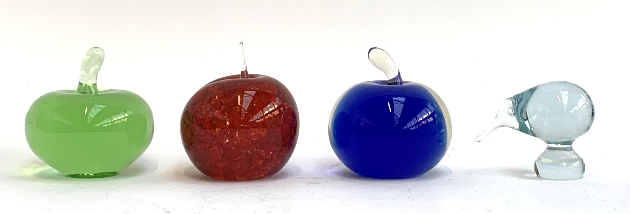 Four glass paperweights to include Liskeard Studio glass red apple paperweight, 9cmH, two other