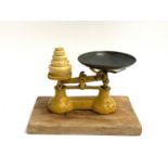 A set of Lewis's 7lb vintage kitchen scales with weights, together with a chopping board