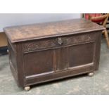 A 17th century oak two panel coffer, carved demilune frieze, on modern casters, 95x41x49cmH (