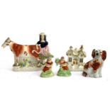A Staffordshire flatback figurine of a lady and cow, together with Staffordshire cottage,