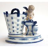 A 20th century porcelain cherub and basket figure, marked 232 to base and impressed with stylised '