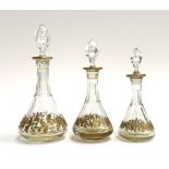 Three graduating St Louis crystal scent bottles with gilt floral band