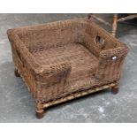 A small well made wicker dog basket, with open carry handles, 63x59x36cmH